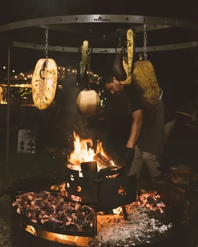 Nahui cooking over an open fire at night