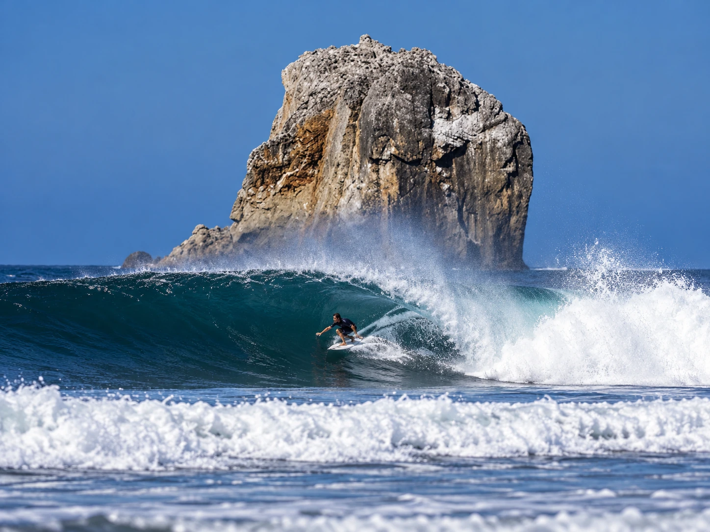 Surfing a wave in front of Witch’s Rock in Guanacaste